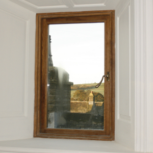 Window with bronze ironmongery with splayed angle painted field and raised panelling